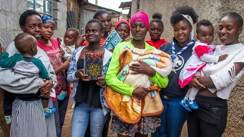Young mother smiling while holding her baby