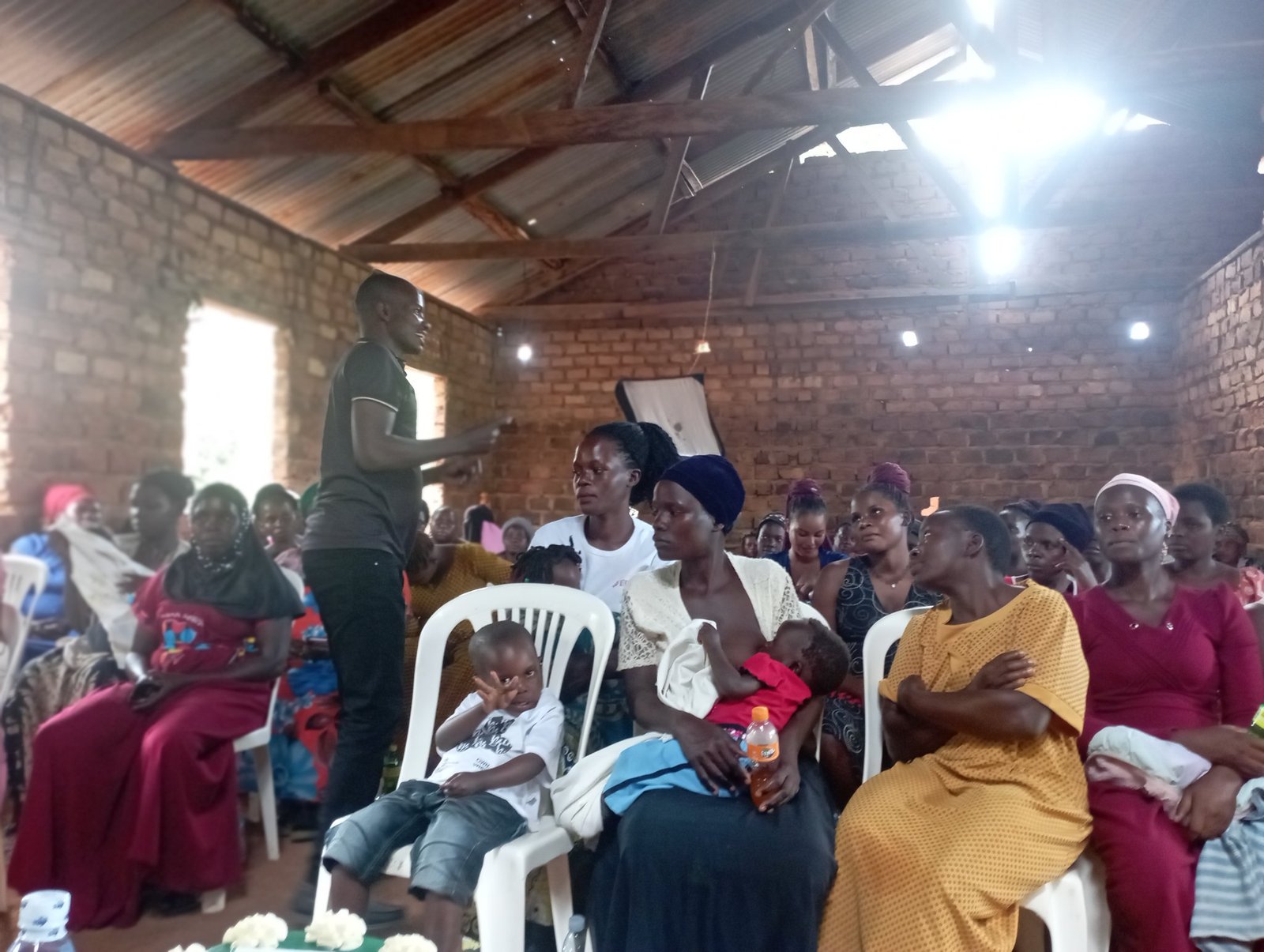 A facilitator conducting a training session for young mothers